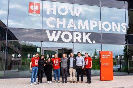people from Strauss and LA FC standing in front of the Strauss headquarter