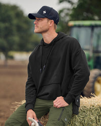 STRAUSS loose fit hoodie in black, worn in lifestyle setting