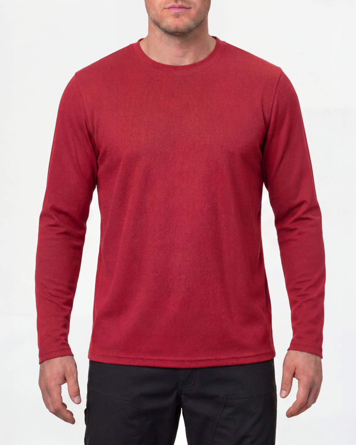 A model wears the STRAUSS Performance Long Sleeve Shirt in fire red with tan work pants and work boots in a studio product scene
