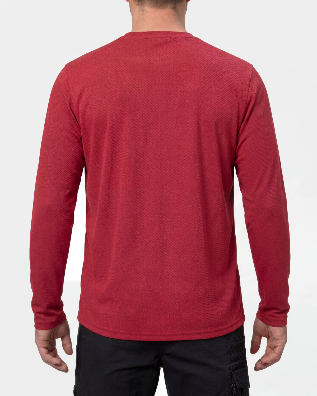 A model wears the STRAUSS Performance Long Sleeve Shirt in fire red with tan work pants and work boots, showing the shirt fit