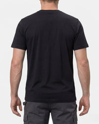 A model wears the STRAUSS T-Shirt e.s.concrete in black with work pants and work boots, showing the shirt fit