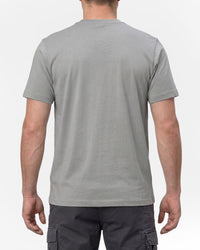 A model wears the STRAUSS T-Shirt e.s.concrete in pearl gray with work pants and work boots, showing the shirt fit