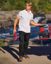 Work Pants e.s.concrete light in black shown in an outdoor workwear setting