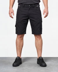 Model wearing Engelbert Strauss e.s. concrete light shorts in black, showing the fit, length, waistband, and front pocket layout of the lightweight work shorts with a practical pocket layout.