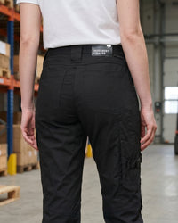 Women's Work Pants e.s.concrete light in black shown in an outdoor workwear setting