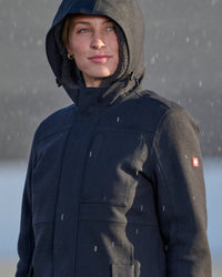 STRAUSS women's e.s.e:pic waterproof rain coat in black shown during outdoor work