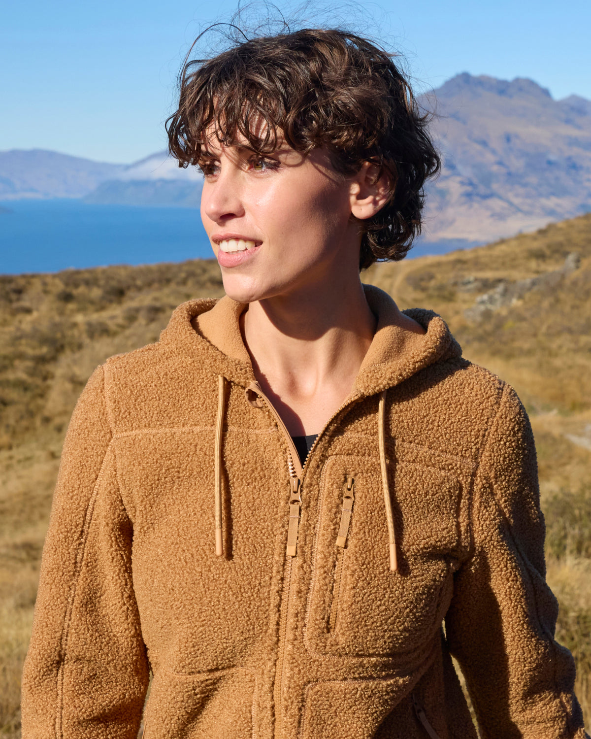 STRAUSS women's e.s.e:pic hooded sherpa fleece jacket in almond brown shown during outdoor work