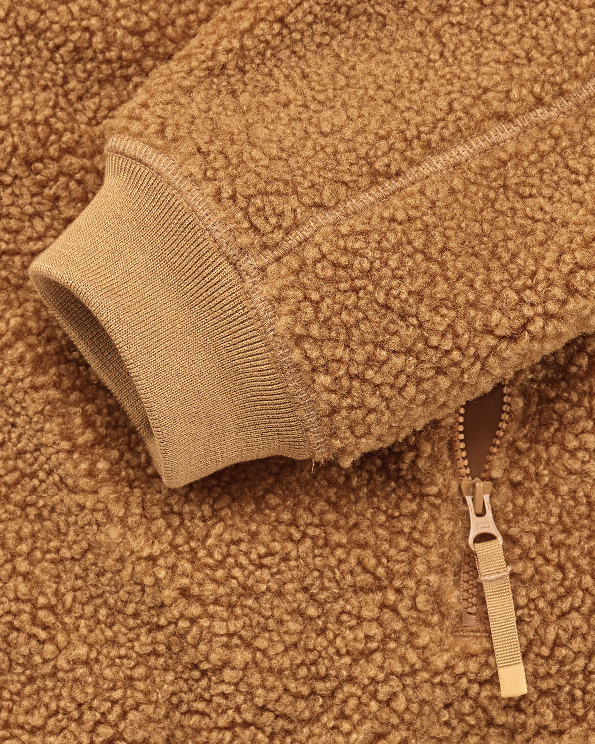 Close-up of zippered pocket details on STRAUSS women's e.s.e:pic hooded sherpa fleece jacket in almond brown