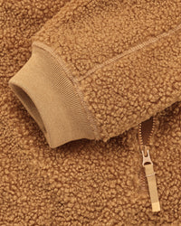 Close-up of zippered pocket details on STRAUSS women's e.s.e:pic hooded sherpa fleece jacket in almond brown