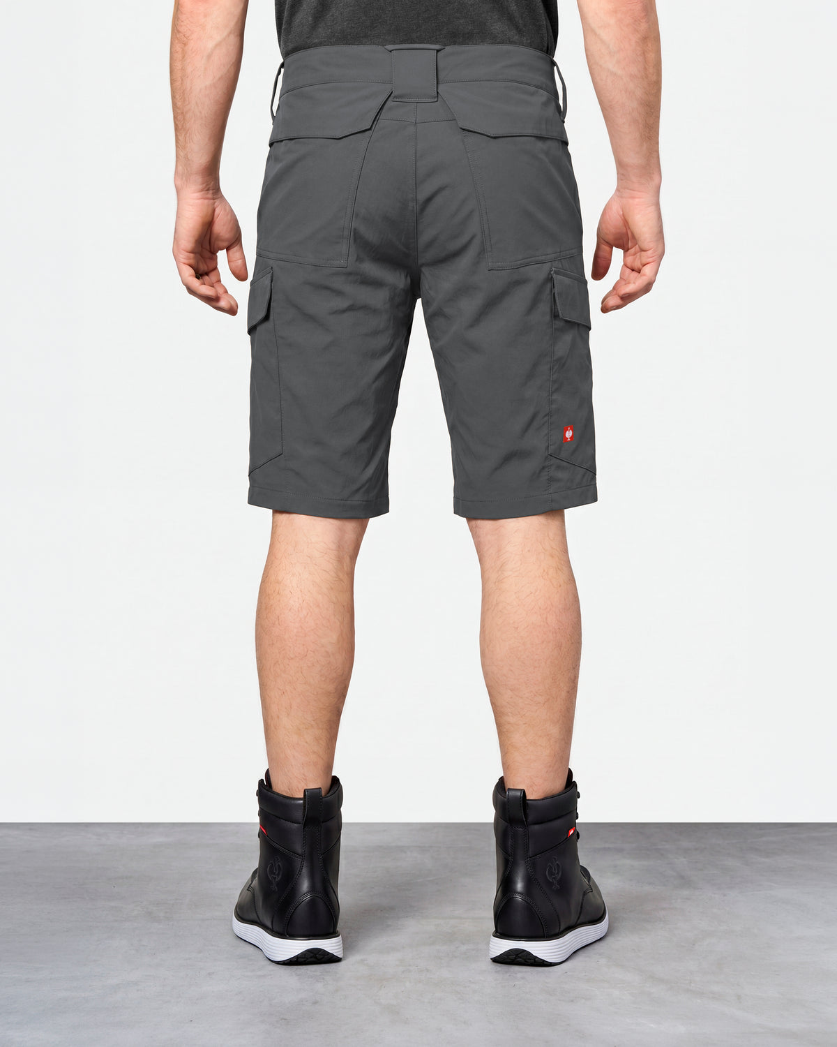 Alternate model view of Engelbert Strauss e.s. taktik stretch ripstop cargo work shorts in carbon gray, showing the side and back fit with visible utility pocket placement and workwear construction.