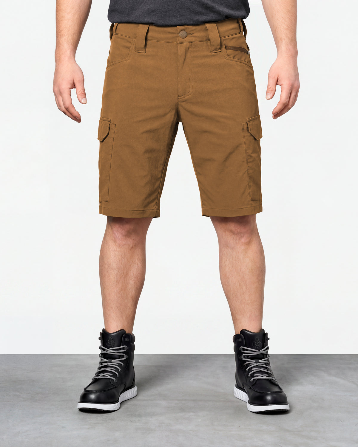 Model wearing Engelbert Strauss e.s. taktik stretch ripstop cargo work shorts in desert brown, showing the fit, length, waistband, and front pocket layout of the durable stretch ripstop cargo work shorts with utility pockets.