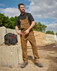 desert brown STRAUSS Stretch Ripstop Cargo Work Bib Overall e.s.taktik worn in a work setting