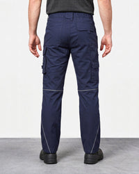 Rear view of a person wearing navy cargo work pants with white contrast stitching, shown against a plain light gray studio background.