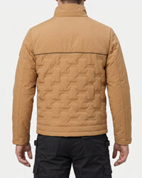 A man viewed from the back wearing a tan quilted jacket with a high collar and black cargo pants, against a light gray studio background.