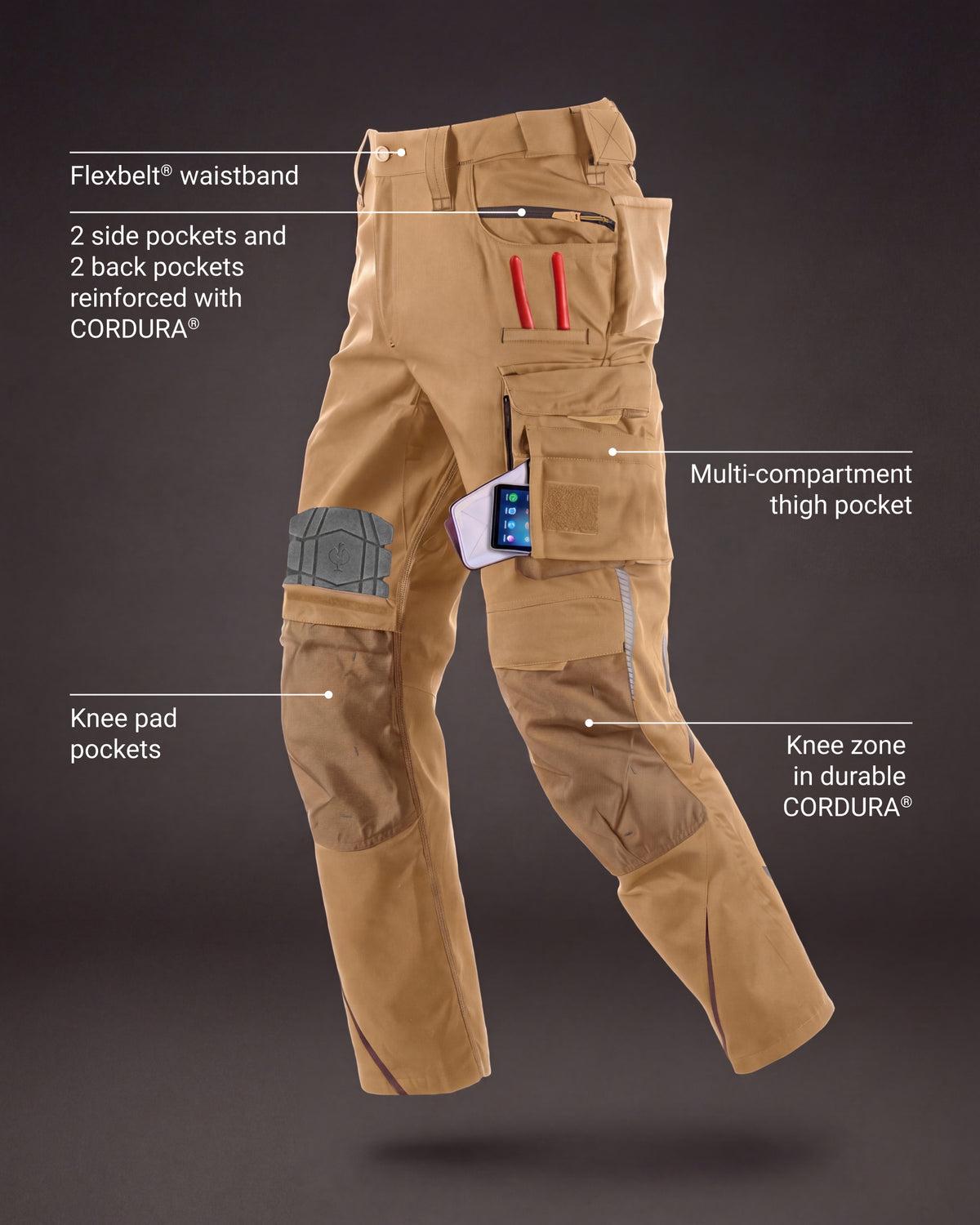 Tan technical cargo pants with multiple pockets, knee pads, and reinforced areas, shown on a dark gray background with callout labels pointing to features like the flexbelt waistband, multi-compartment thigh pocket, knee pad pockets, and knee zone in durable CORDURA fabric.