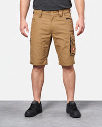 A person wearing tan cargo shorts with black sneakers, shown from the waist down against a plain light gray studio background.