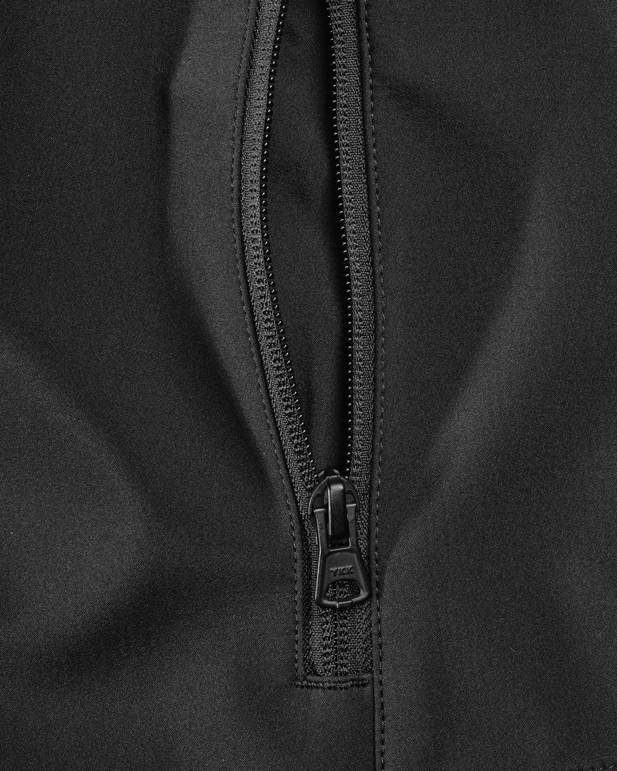 Close-up of pocket and hood details on STRAUSS e.s.trail pure softshell jacket in black