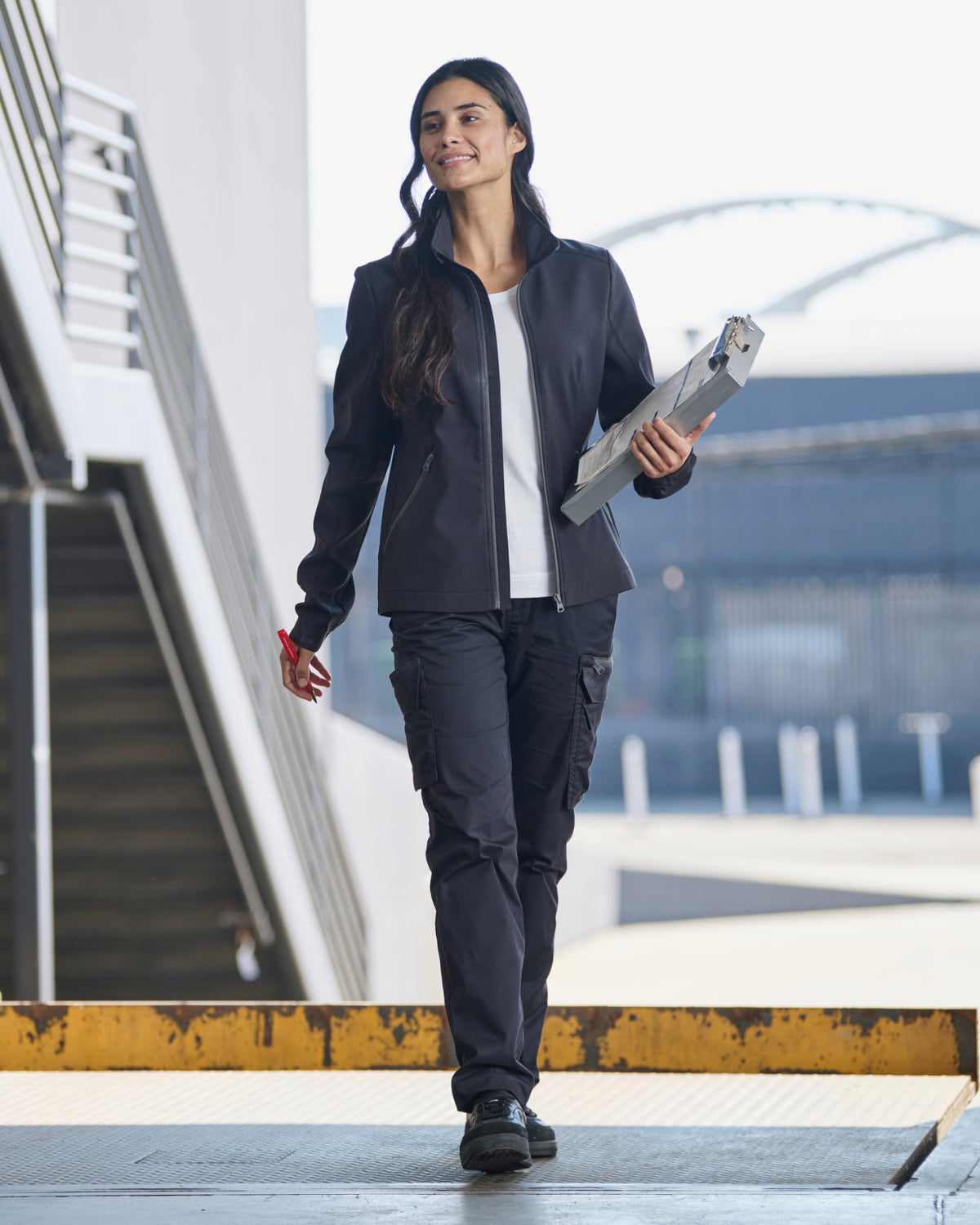 STRAUSS women's e.s.trail pure softshell jacket in black shown during outdoor work