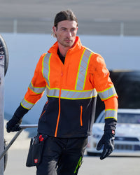 STRAUSS Class 2 high visibility softshell jacket in neon orange and black worn for high-visibility work