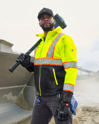 STRAUSS Class 2 high visibility softshell jacket in neon yellow and black worn for high-visibility work