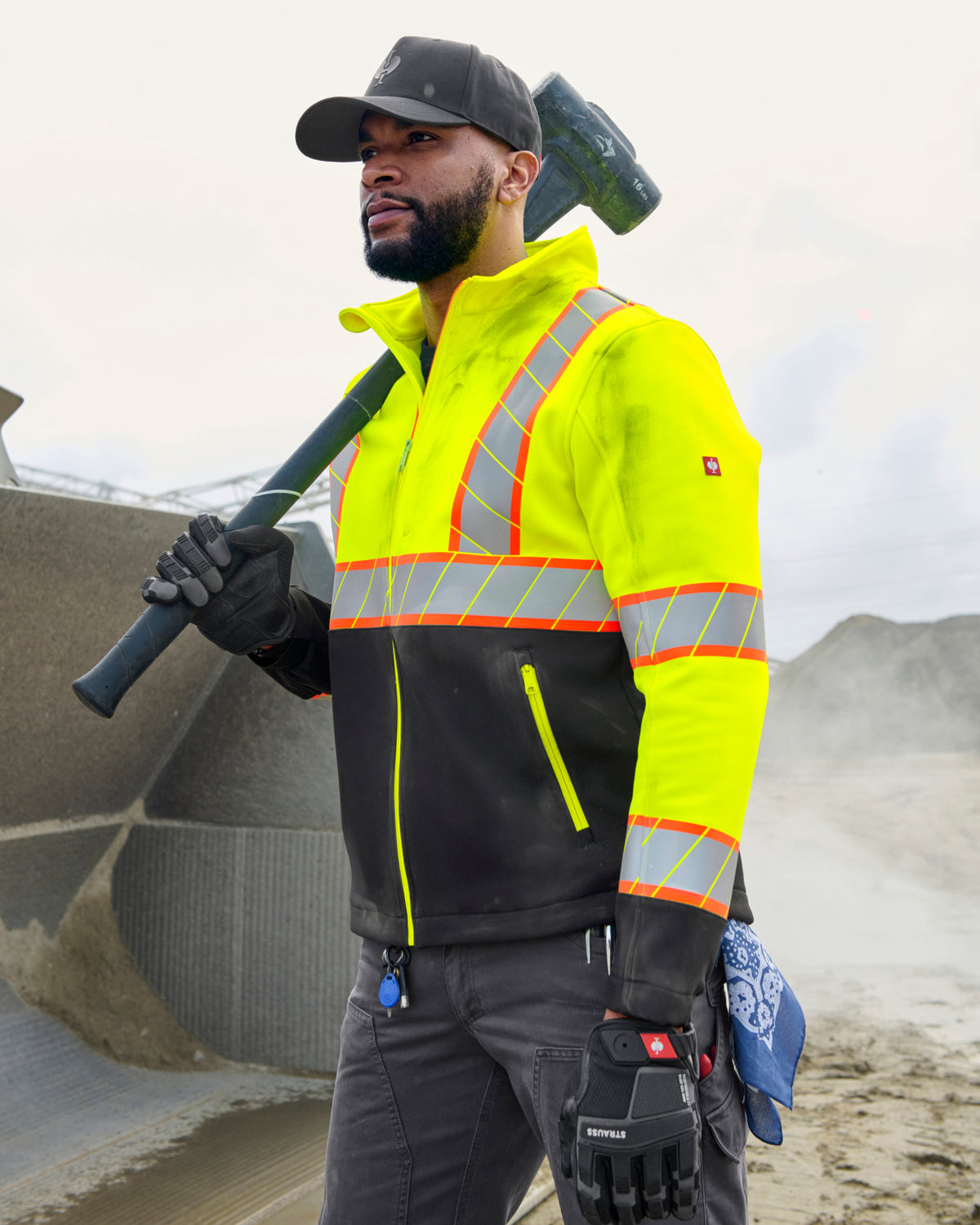 STRAUSS Class 2 high visibility softshell jacket in neon yellow and black shown on an outdoor jobsite