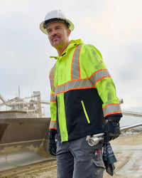 STRAUSS Class 2 high visibility waterproof jacket in neon yellow and black in use with workwear