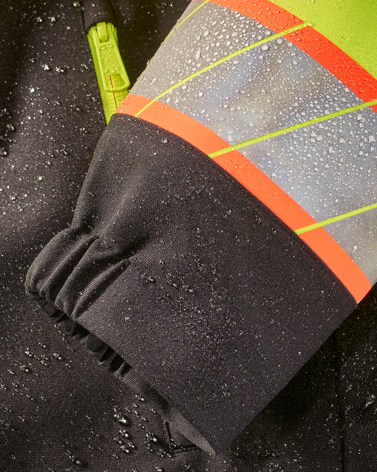 Close-up of zipper and pocket details on STRAUSS Class 2 high visibility waterproof jacket in neon yellow and black
