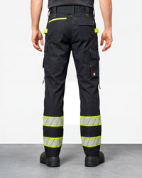Enhanced Visibility Work Pants in black worn by a model, rear view