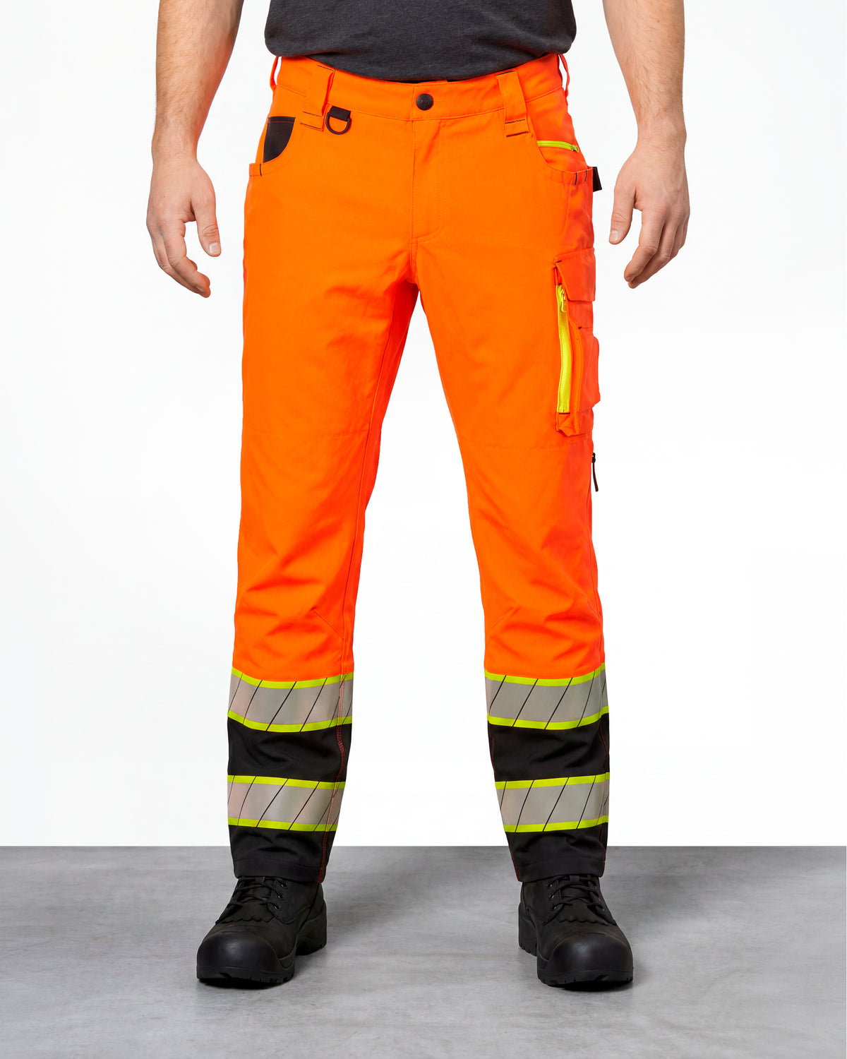 High Visibility Work Pants in neon orange/black worn by a model, front view