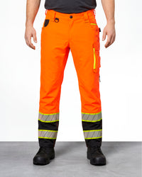 High Visibility Work Pants in neon orange/black worn by a model, front view