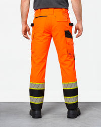 High Visibility Work Pants in neon orange/black worn by a model, rear view