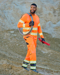High Visibility Work Pants in neon orange/black in use, showing fit and movement
