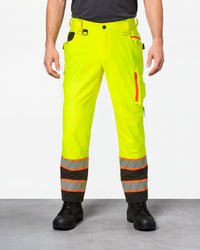 High Visibility Work Pants in neon yellow/black worn by a model, front view