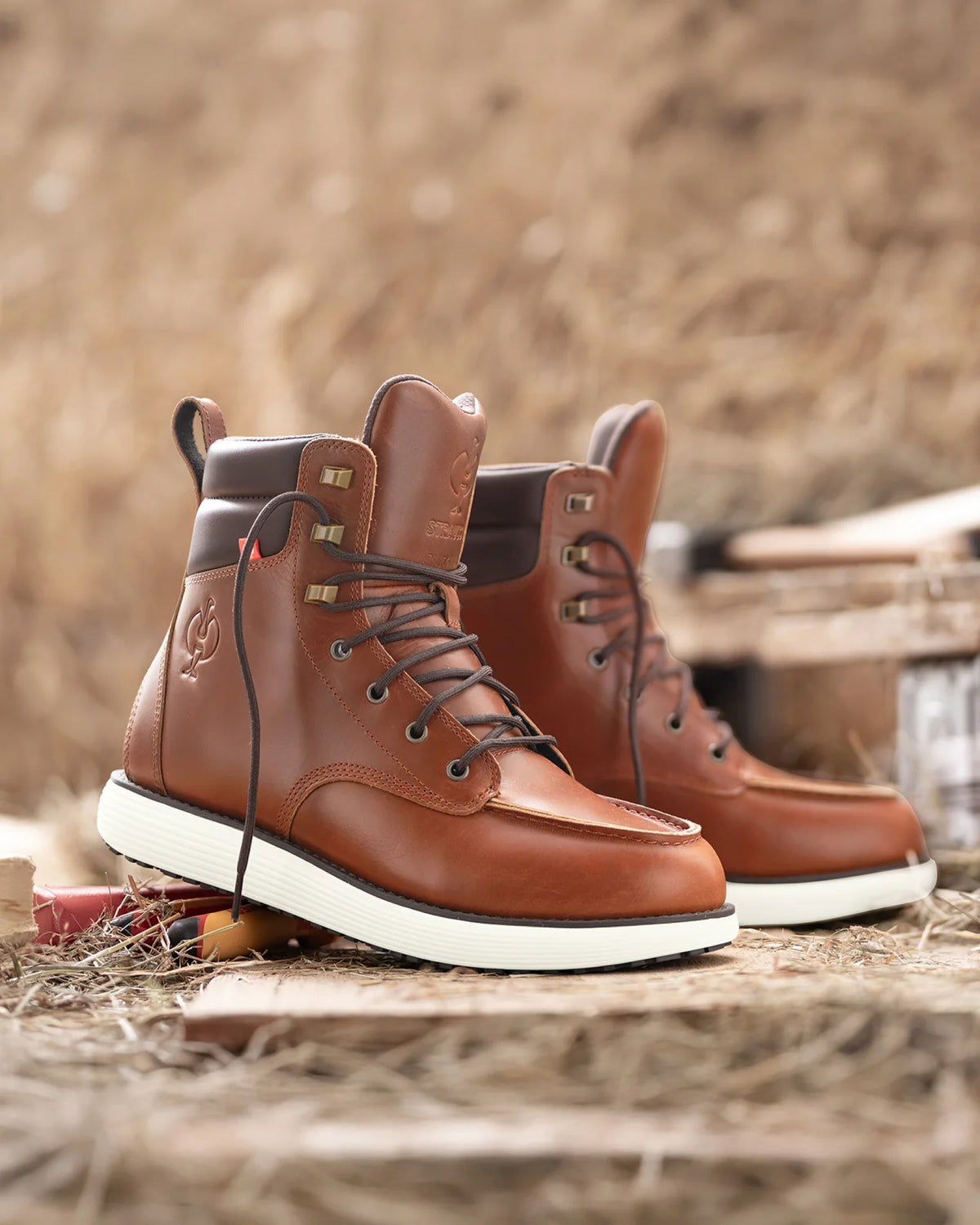 STRAUSS Boulder 6-inch Soft Toe Boot in Red brown worn in an outdoor work setting