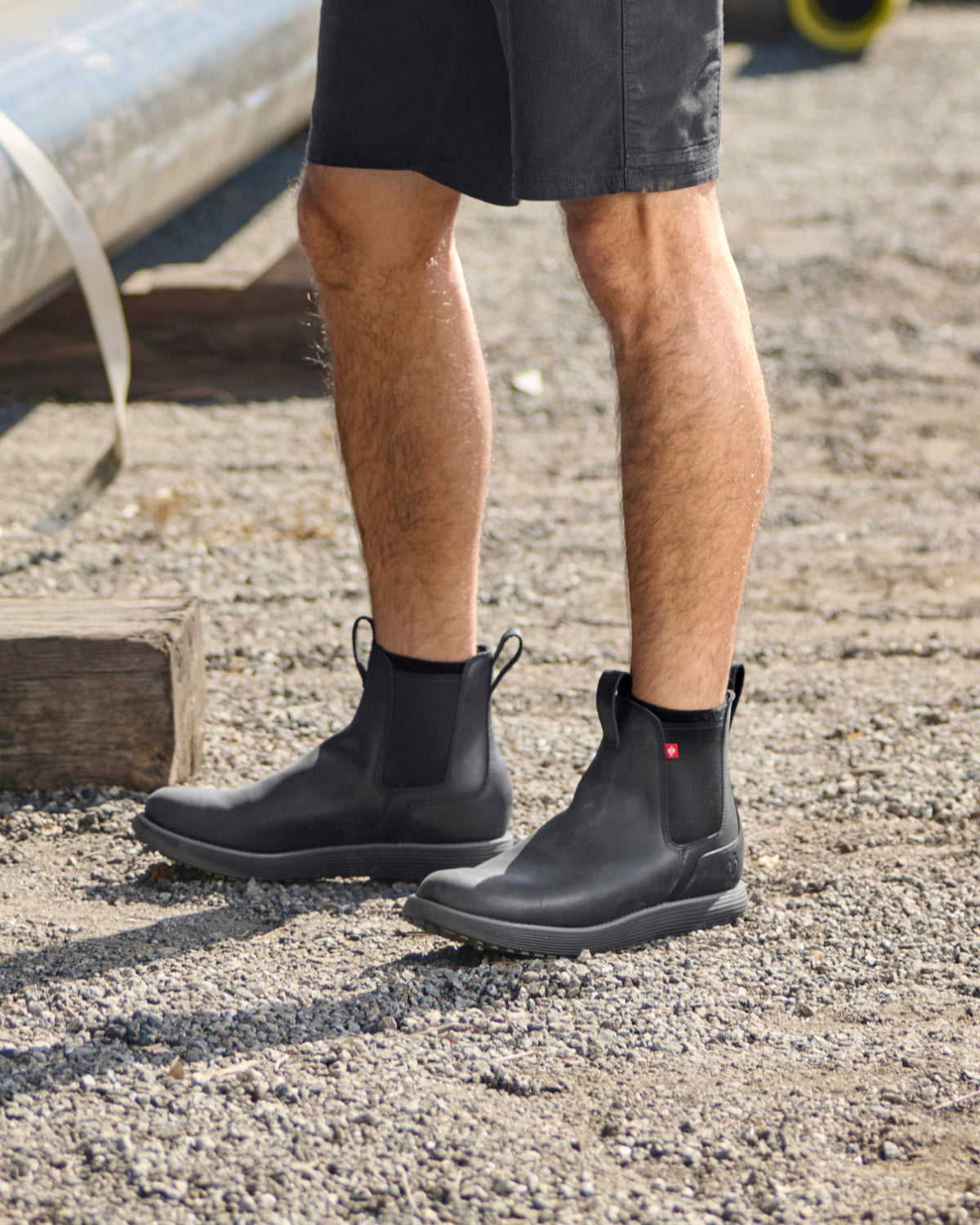 STRAUSS Amarillo 6-inch Soft Toe Chelsea Boot in Black worn in an outdoor work setting