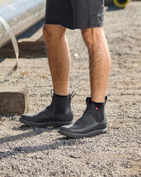 STRAUSS Amarillo 6-inch Soft Toe Chelsea Boot in Black worn in an outdoor work setting