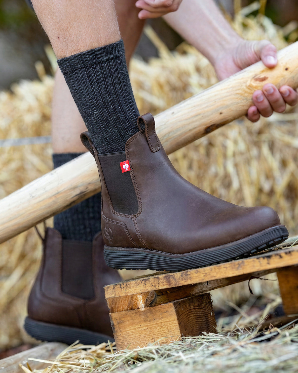 STRAUSS Amarillo 6-inch Soft Toe Chelsea Boot in Marsh brown shown on rough jobsite ground