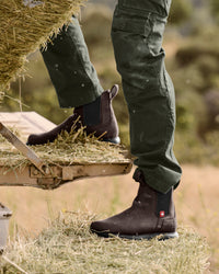 STRAUSS Amarillo 6-inch Soft Toe Chelsea Boot in Marsh brown worn in an outdoor work setting