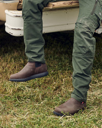 STRAUSS Amarillo 6-inch Soft Toe Chelsea Boot in Marsh brown with workwear in a jobsite scene