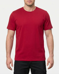 A model wears the STRAUSS Cotton Stretch T-Shirt in fire red in a studio product scene