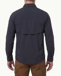 A model wears the STRAUSS e.s.taktik Stretch Ripstop Long Sleeve Work Shirt in nero blue open over a T-shirt with work pants and work boots, showing the shirt fit
