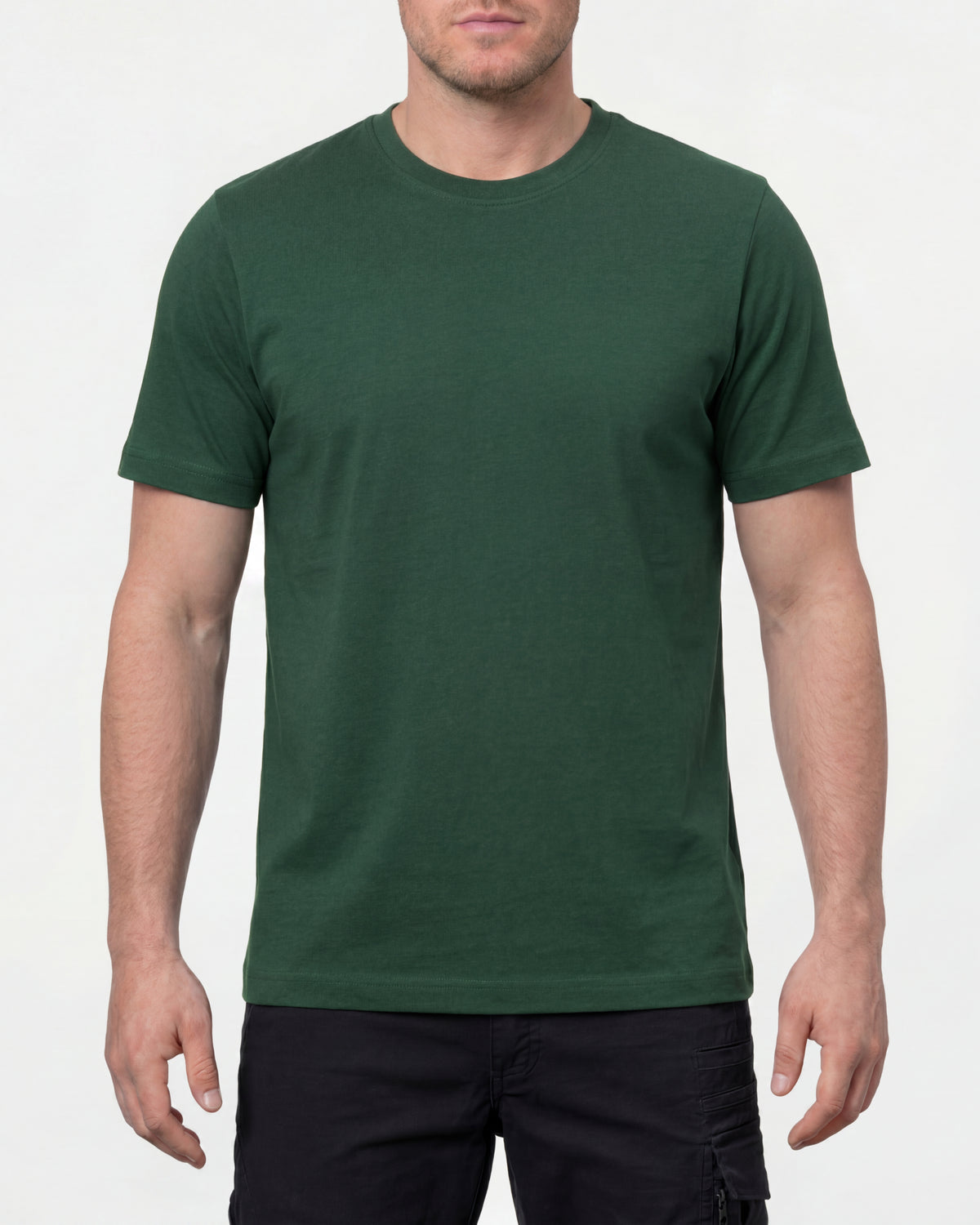 A model wears the STRAUSS Cotton T-Shirt in green with tan work pants and work boots in a studio product scene