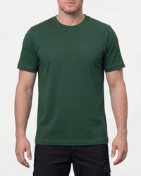 A model wears the STRAUSS Cotton T-Shirt in green with tan work pants and work boots in a studio product scene