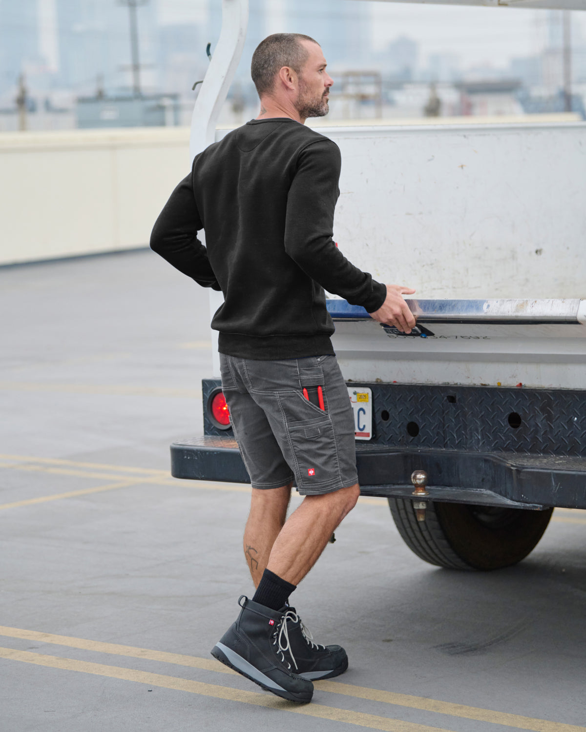 STRAUSS cotton-poly crew neck sweatshirt in black, worn in casual workwear setting