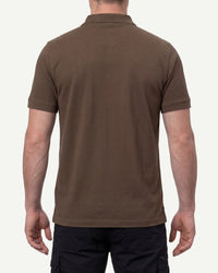 A model wears the STRAUSS Cotton Polo Shirt in hazelnut with tan work pants and work boots, showing the shirt fit
