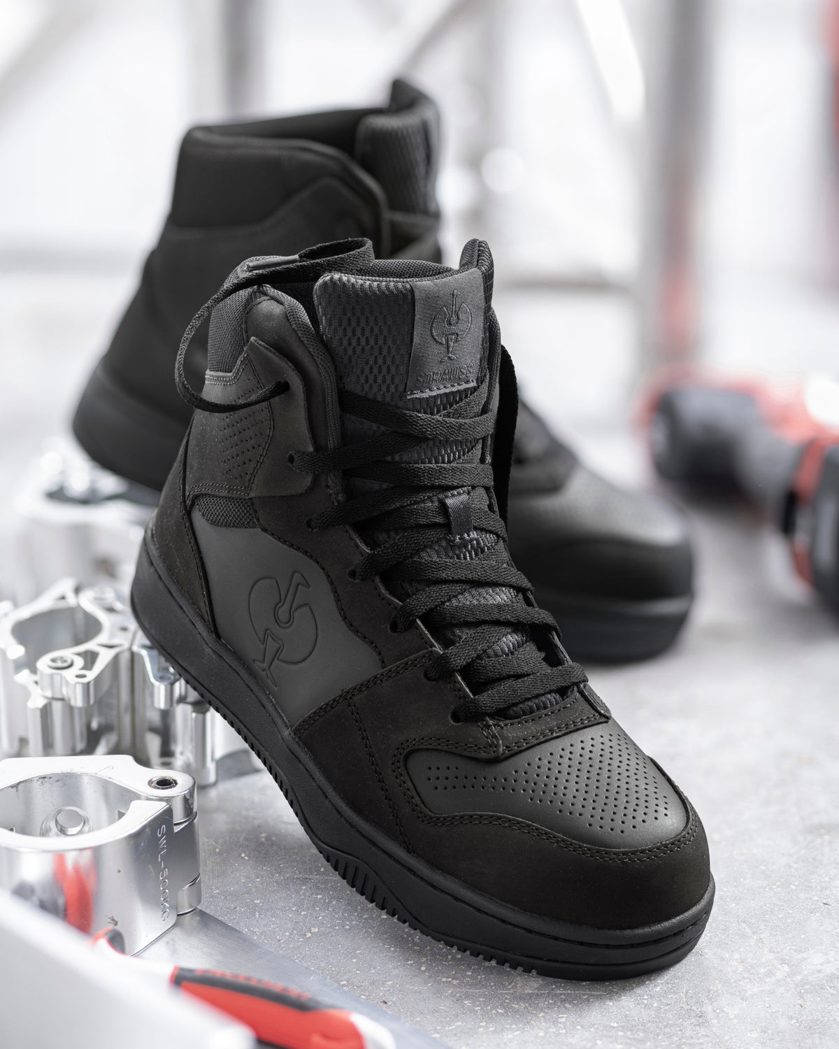STRAUSS Eindhoven 6-inch Steel Toe Work Boot in Black worn in an outdoor work setting