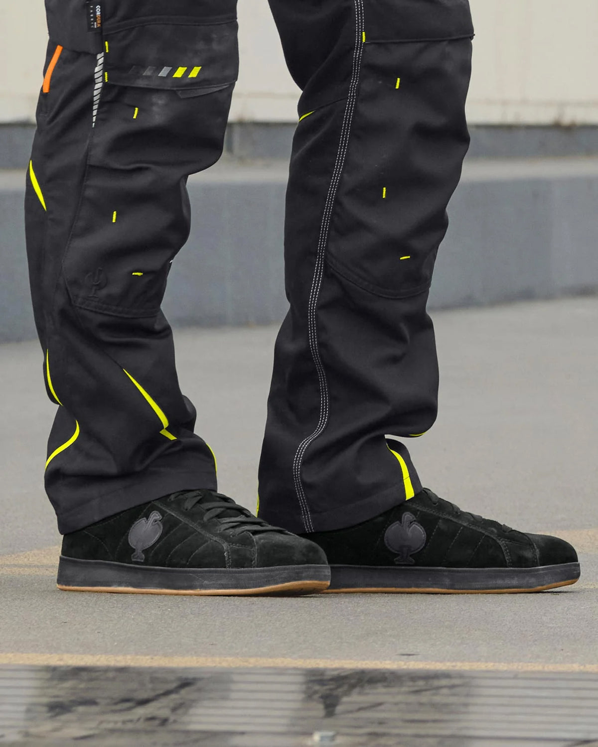 STRAUSS Tampa Steel Toe Work Shoe in Black shown on rough jobsite ground
