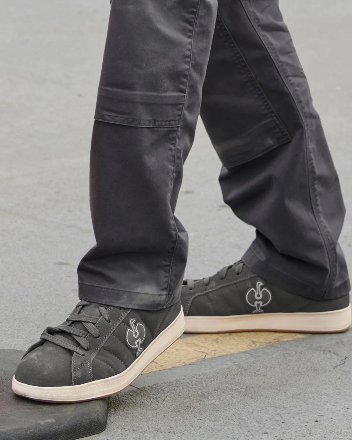 STRAUSS Tampa Steel Toe Work Shoe in Carbon gray shown on rough jobsite ground