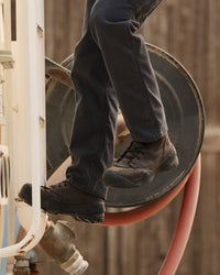 STRAUSS Edmonton 8-inch Steel Toe Work Boot in Brown worn in an outdoor work setting