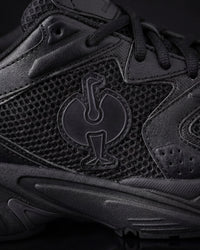 Close-up of the Black St. Louis Composite Toe Work Shoe STRAUSS logo